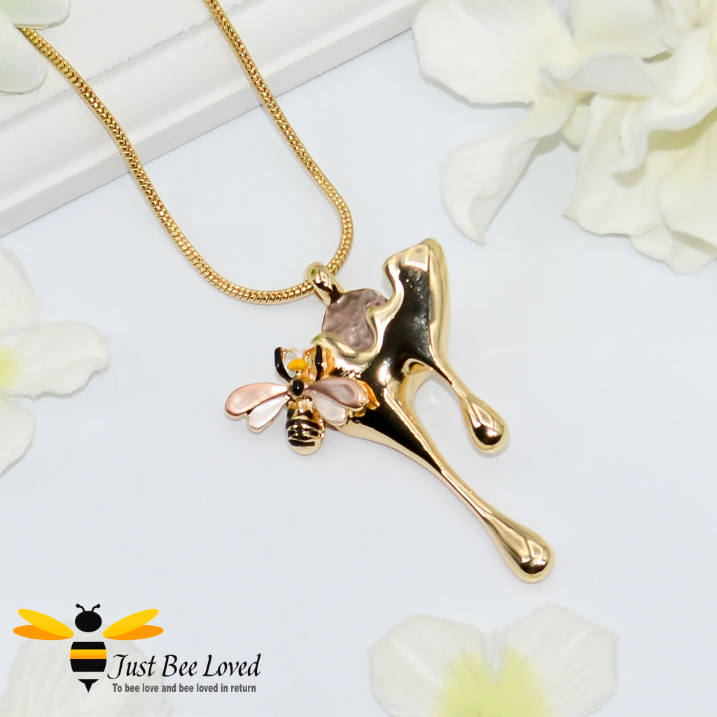 gold plated pendant necklaces each featuring golden honey drips, enamelled filled honeycomb to look like pollen with a honeybee.  