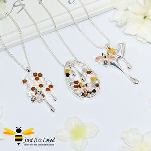 silver plated pendant necklaces each featuring golden honey drips, enamelled filled honeycomb to look like pollen with a honeybee.  