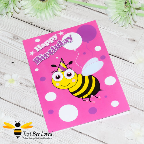 image of a pink bee themed birthday card featuring a cartoon illustrations of a young bee wearing a party hat with white and purple balloons.