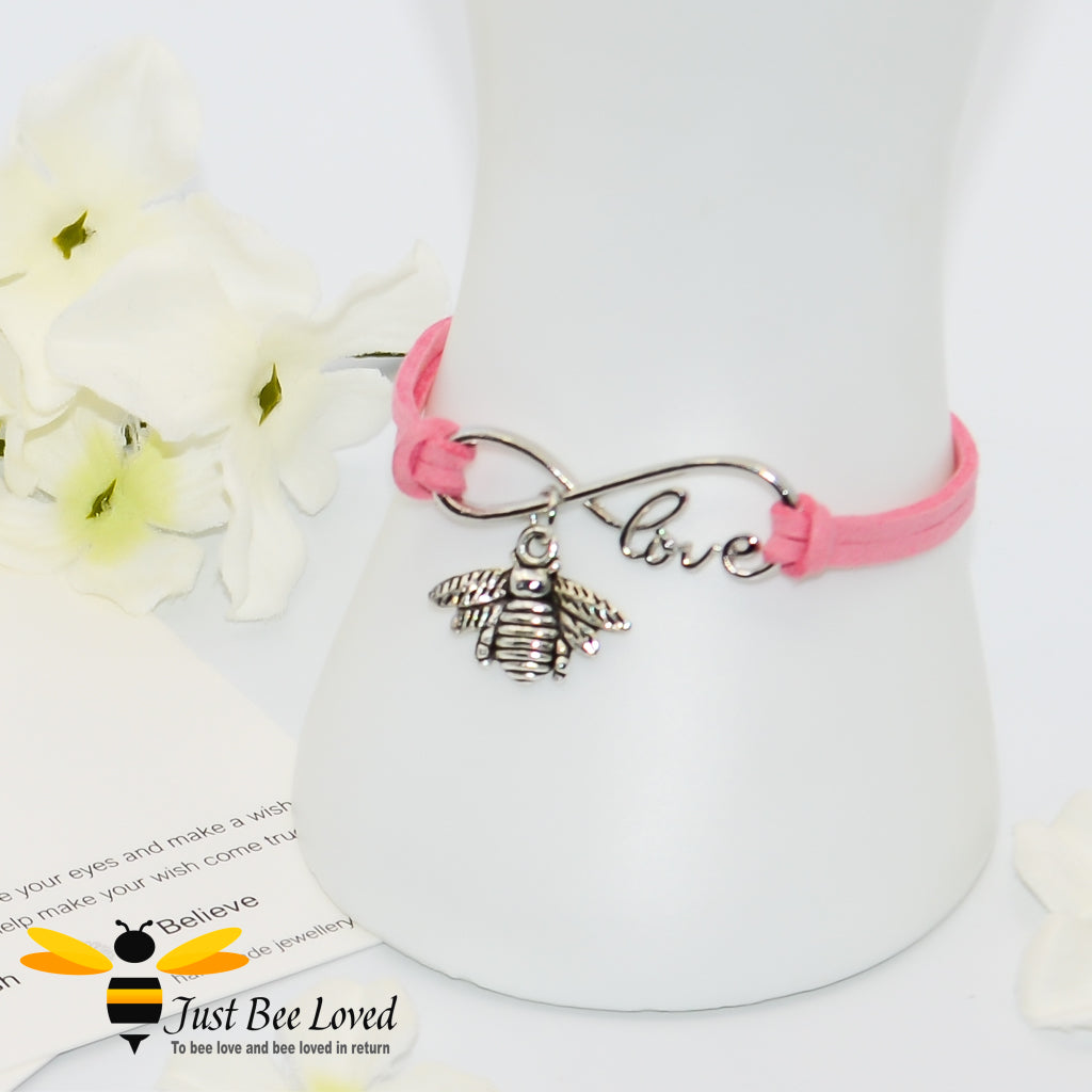 pink faux leather bracelet featuring a bee charm with love link