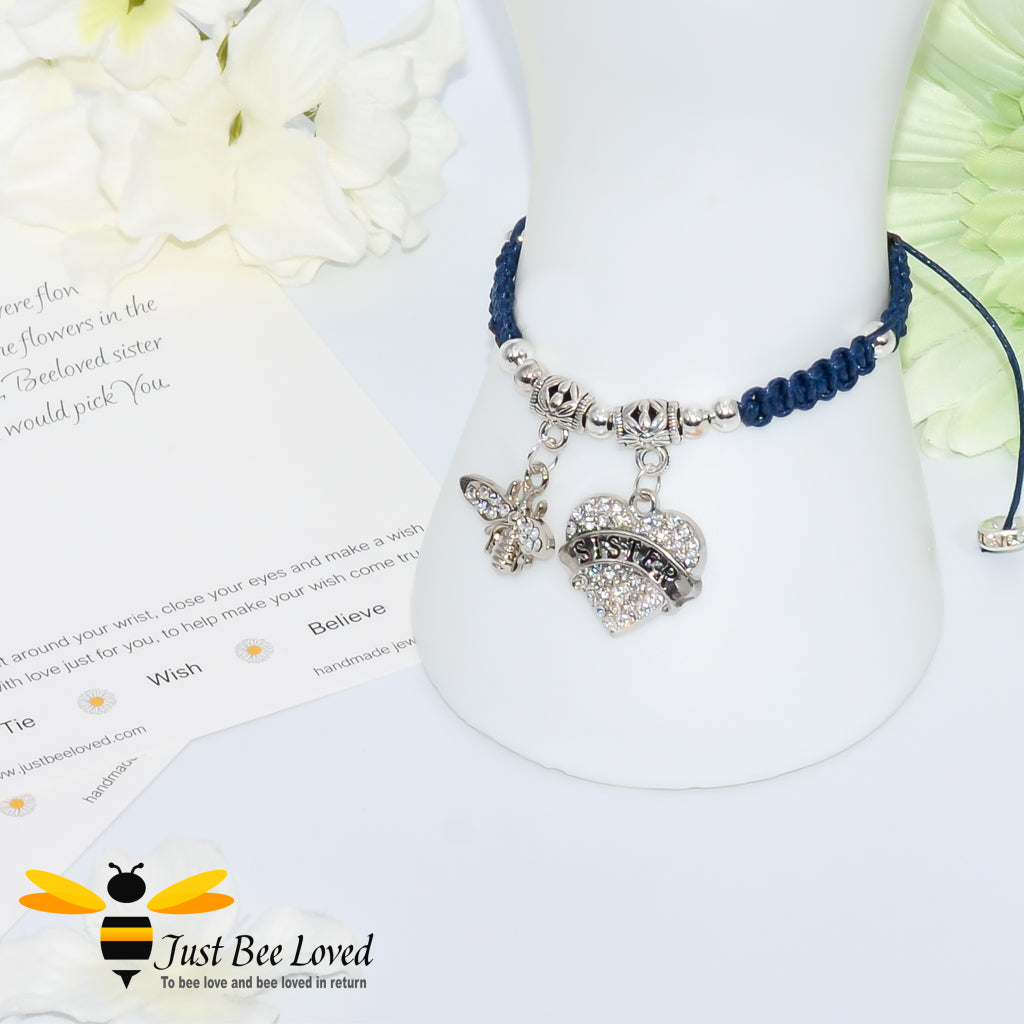 Navy Shamballa wish bracelet featuring a crystal bee and heart charm engraved with "Sister" and a sister verse card.