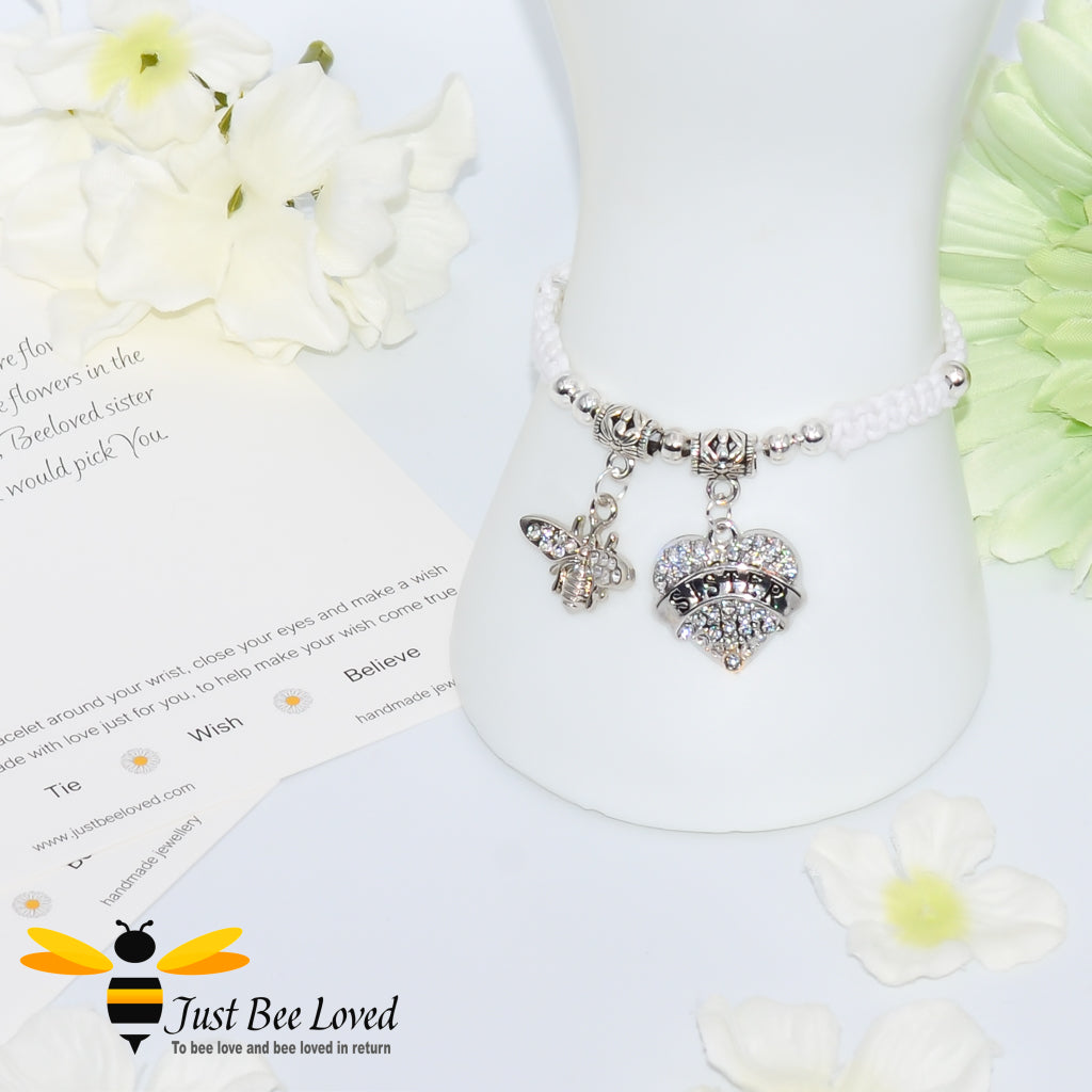 White Shamballa wish bracelet featuring a crystal bee and heart charm engraved with "Sister" and a sister verse card.