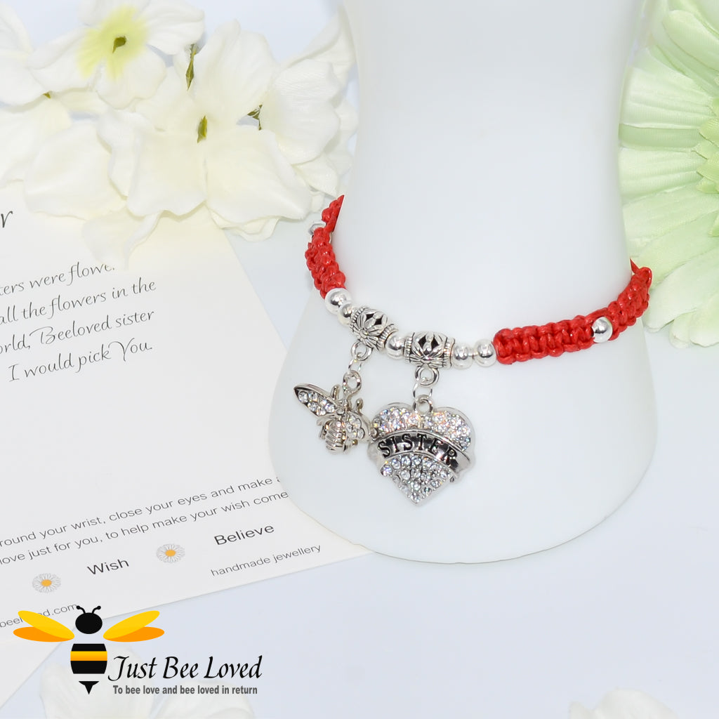 Red Shamballa wish bracelet featuring a crystal bee and heart charm engraved with "Sister" and a sister verse card.