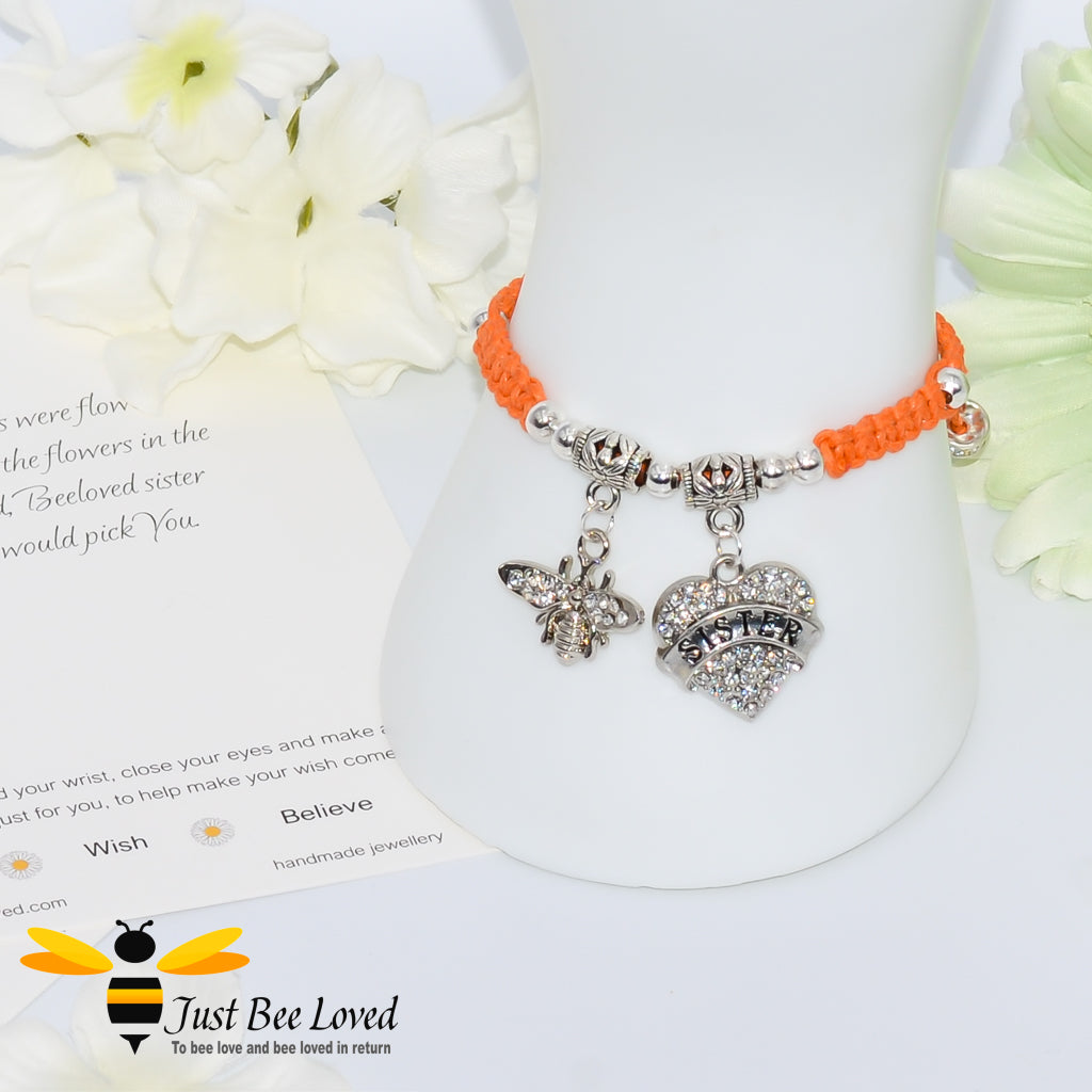 Orange Shamballa wish bracelet featuring a crystal bee and heart charm engraved with "Sister" and a sister verse card.