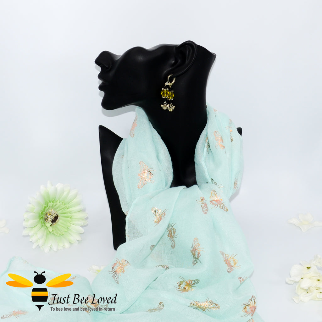 women's lightweight pastel green scarf with gold bees print.