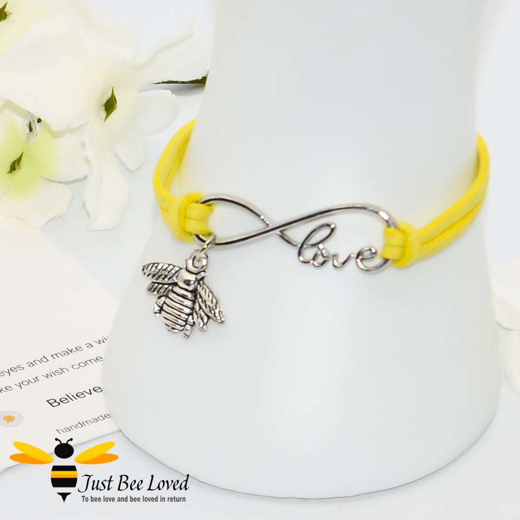 Yellow faux leather bracelet featuring a bee charm with love link